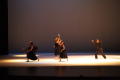 Photograph: [Photograph of six dancers standing on stage in black clothing]