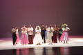 Primary view of [Photograph of dancers in wedding attire lined up on stage after a performance]