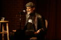 Photograph: [Photograph of Melvin Van Peebles as he talks on stage at a film fest…