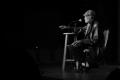 Photograph: [Photograph of Melvin Van Peebles seated on a stage]