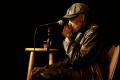 Photograph: [Photograph of Melvin Van Peebles sitting on stage at a film festival]