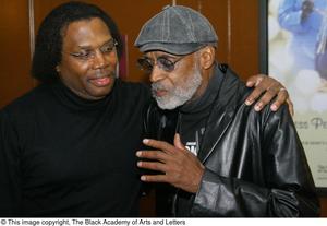 Primary view of object titled '[Photograph of Curtis King standing with Melvin Van Peebles]'.