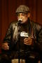 Photograph: [Photograph of Melvin Van Peebles giving a talk on stage]