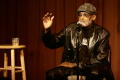 Primary view of [Photograph of Melvin Van Peebles giving a talk on stage at a film festival]