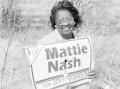 Photograph: [Mattie Nash smiling with her campaign sign]