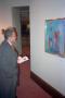 Photograph: [Photograph of guest looking at oil painting]