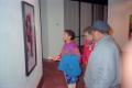 Photograph: [Exhibition guests viewing a painting on display]