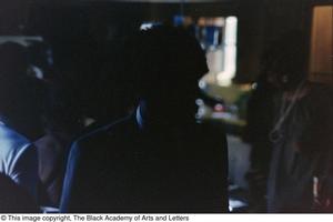 Primary view of object titled '[Dark photograph of a shadowed suited individual]'.