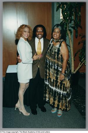 Primary view of object titled '[Photograph of Curtis King with two women on each side of him]'.