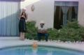 Thumbnail image of item number 1 in: '[Photograph of a woman standing with a man next to a pool]'.
