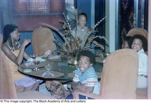 Primary view of object titled '[Photograph of a woman and four boys sitting at a dining table]'.