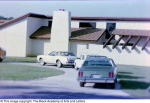 Primary view of object titled '[Photograph of parked cars outside of Tony Dorsett's house]'.