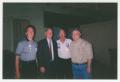Photograph: [Photo of Howard Dean with three men]