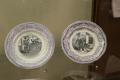 Photograph: [Two souvenir plates on display]