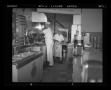 Photograph: [Ernie in the kitchen with a cook]