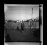 Primary view of [Charles Williams standing in a yard]