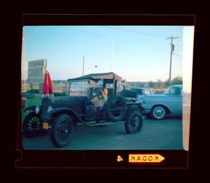 Primary view of object titled '[Photograph of Pam Williams in a vintage automobile]'.