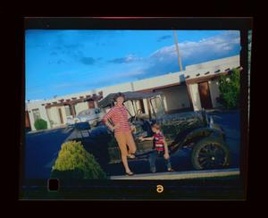 Primary view of object titled '[Photograph of Carol and Byrd Williams IV sitting on a vintage car]'.