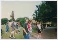 Photograph: [Photograph of TAMS students walking by statue]