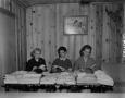 Photograph: [Three women opening letters]