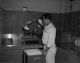 Photograph: [Man measuring out sodium sulfite]