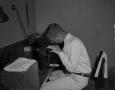 Photograph: [Man looking into a microscope]