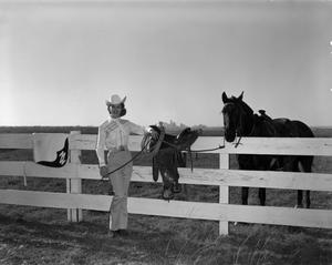 Primary view of object titled '[Linda Loftis posing next to a horse]'.