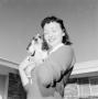 Photograph: [Woman holding a puppy]