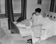 Photograph: [Women lounging on a bed]