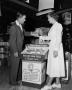 Photograph: [Two people next to a Borden cheese display]
