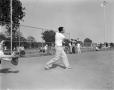 Photograph: [Man hits a ball with a bat at WBAP picnic]