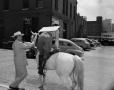 Photograph: [Woman dismounting a horse]