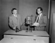 Primary view of [Photo of two men conducting an experiment]