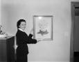Photograph: [Margaret McDonald holding a portrait drawing of Mrs. Tucker]