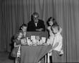 Photograph: [Photograph of Bobby Peters and guests looking at prizes]
