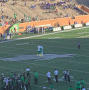 Photograph: [Albino Squirrel Mascot and Scrappy Hugging at UNT Home Football Game]