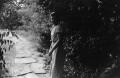 Photograph: [Photograph of Mary Liddell on a stone path]