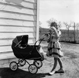 Primary view of object titled '[Carol Pushing a Stroller]'.