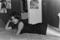 Photograph: [Photograph of Pam Williams posing on a bed, 2]
