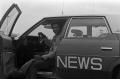 Photograph: [KXAS employee sitting in a news automobile, 3]