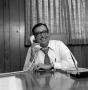Photograph: [Photo of Ron Godbey speaking on a telephone]