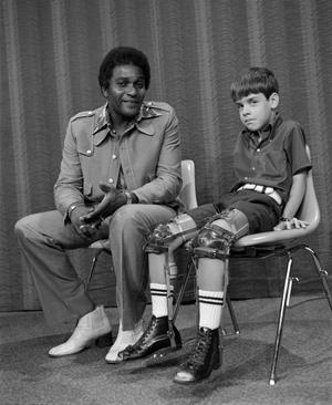 Primary view of object titled '[Charley Pride and a young child with MDS]'.