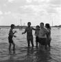 Photograph: [Norman with children at the beach]