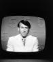 Photograph: [Ron Spain on a television screen]