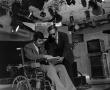 Photograph: [Man seated in wheelchair on set]