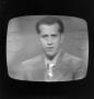 Photograph: [Ward Andrews on a television screen]