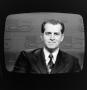 Photograph: [Man on a television screen]