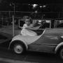 Photograph: [Photograph of Carol Williams in a toy car]