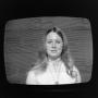 Photograph: [Woman on television]