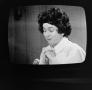 Photograph: [Woman on television]